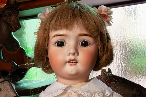 Vintage & antique toys. Retro porcelain doll close up.