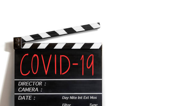 COVID-19 text title on film slate .