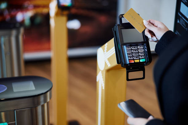 istock Young woman using gold card for contactless payment 1215185239