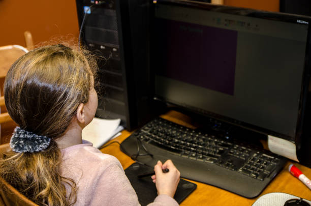 istock Young girl behind a PC screen 1215185928