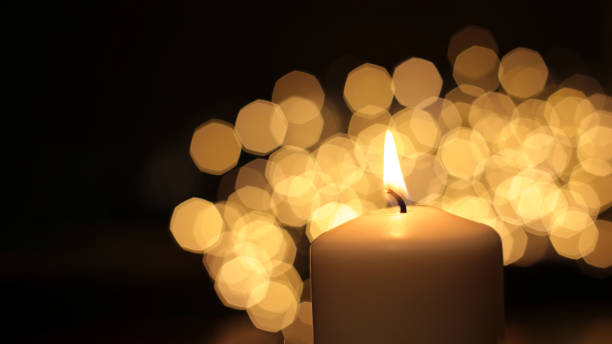 istock Mourning candle of sadness and longing. Festive fire macro background. 1215186617