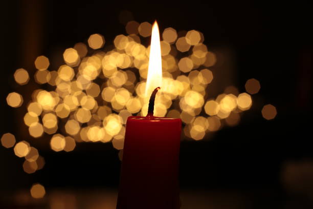 istock Mourning candle of sadness and longing. Festive fire macro background. 1215187107