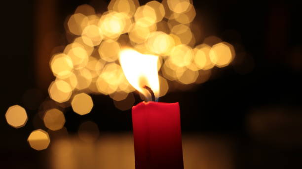 istock Mourning candle of sadness and longing. Festive fire macro background. 1215187125