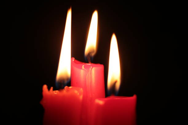 istock Mourning candle of sadness and longing. Festive fire macro background. 1215187714