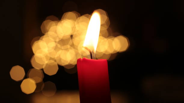 istock Mourning candle of sadness and longing. Festive fire macro background. 1215187827