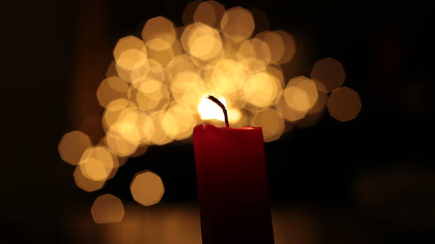 istock Mourning candle of sadness and longing. Festive fire macro background. 1215187834
