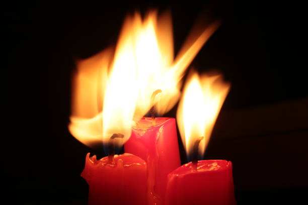 istock Mourning candle of sadness and longing. Festive fire macro background. 1215187889