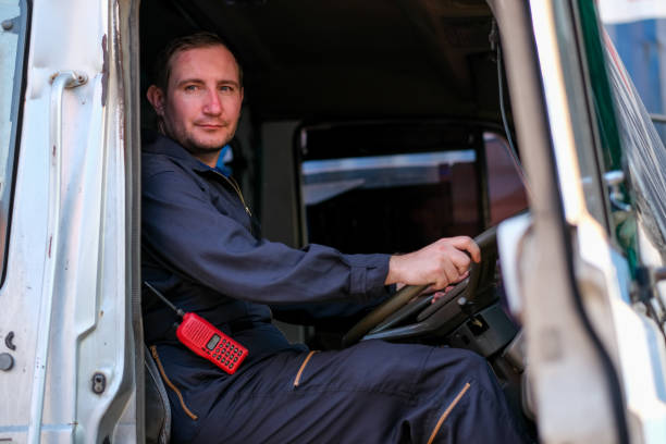 istock Technician or worker sit on driver seat and look to the camera in cargo container shipping area 1215187916