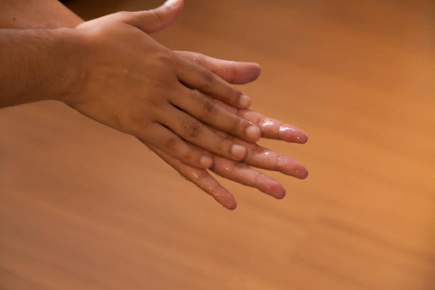 istock Sanitizing hands with alcohol gel - Hand hygiene with alcohol gel 1215188376