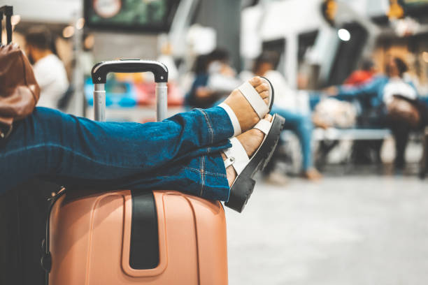Passenger relaxing legs over luggage