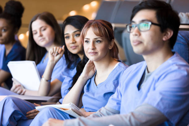 istock College students in scrubs listen to lecture 1215188742