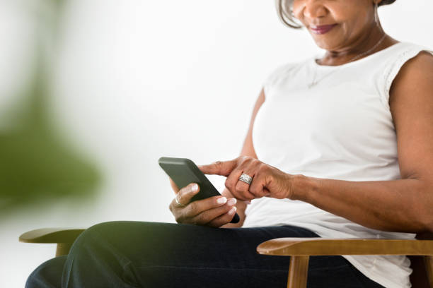 istock Confident woman using smartphone 1215188820