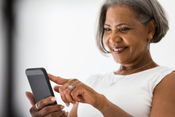 istock Smiling senior woman scrolling through social media 1215188822