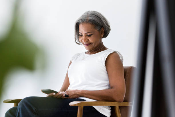 istock Relaxed woman using smartphone 1215188827