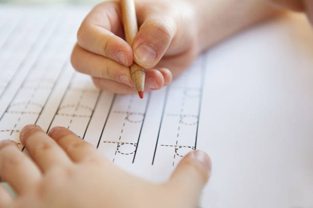 Close-up  pencil in the hand of child. stock photo