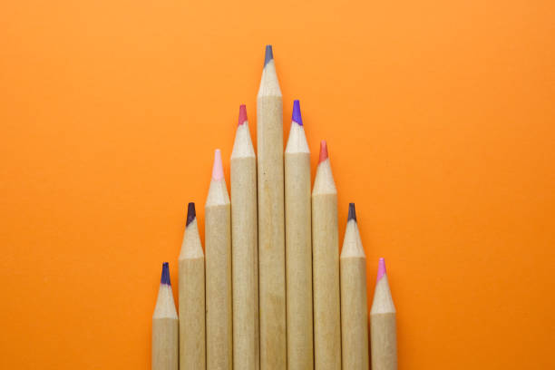 istock multicolored pencils growing row isolated on orange 1215193513