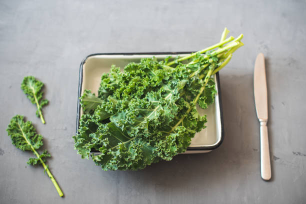 istock Green Organic healthy fresh Kale or leaf cabbage in a white enameled container 1215193892