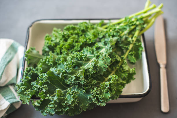 istock Green Organic healthy fresh Kale or leaf cabbage in a white enameled container 1215193920