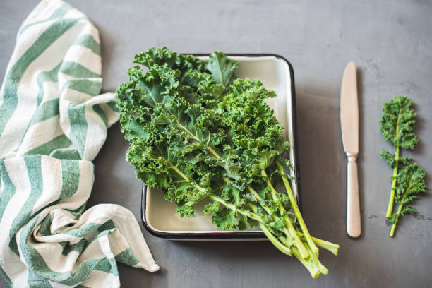 istock Green Organic healthy fresh Kale or leaf cabbage in a white enameled container 1215193942