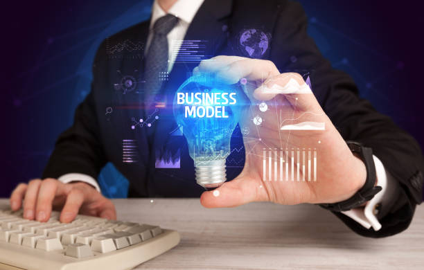 istock Businessman holding a light bulb, new business concept 1215194081