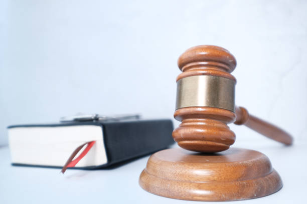 istock Close up of gavel, book and handcuff on table 1215194140
