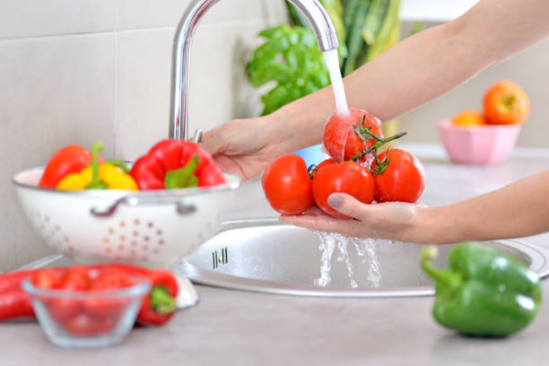 Washing vegetables. Preparing food. Food products on the kitchen countertop. food hygene stock pictures, royalty-free photos & images