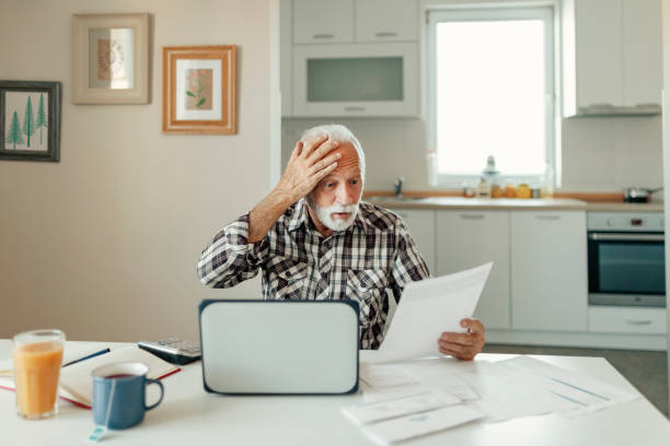 istock Stressed Elderly Man Calculating Home Finances 1215200444