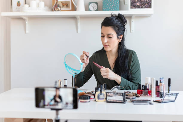 istock Woman Vlogging Herself About Beauty Products 1215201267