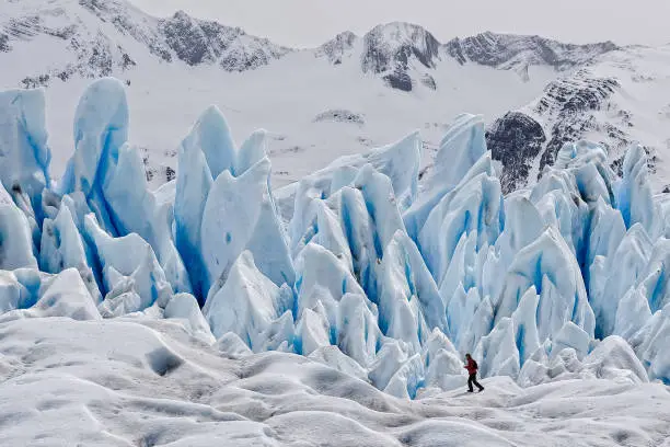 A hiker on blue ice at Perito Moreno Glacier, one of the most important tourist attractions in the Patagonia, located in the Los Glaciares National Park in southwest Santa Cruz, Argentina.