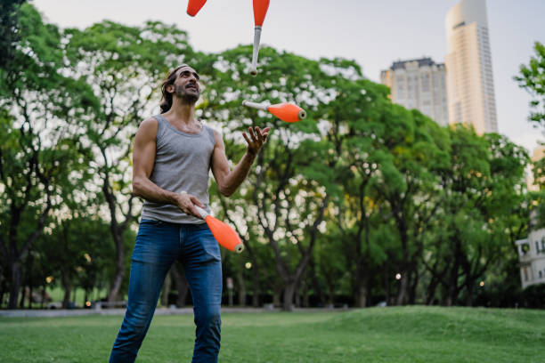 istock Man juggling with cones in park 1215202434