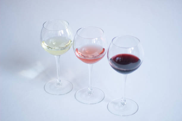 istock White, pink, red wine in glasses on white background isolated 1215204747