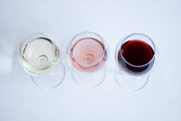 istock White, pink, red wine in glasses on white background isolated 1215204782