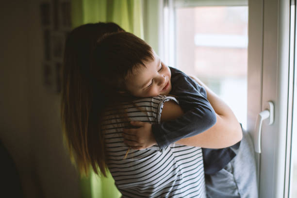 istock Mother and son embracing at home 1215204846