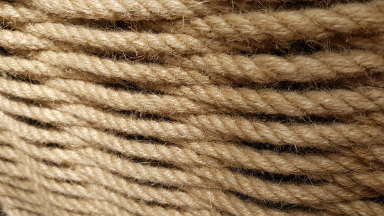 Rope texture close-up. Rough patterned background. Wicker and woven textures. Thread and yarn material.