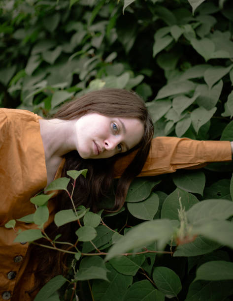 istock Young beautiful woman walking in public park 1215207396
