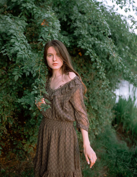 istock Young woman walking in the forest 1215207545