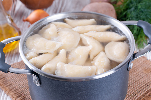 Boiling dumplings in the pan. Varenyky, vareniki, pierogi, pyrohy