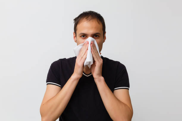 istock Close-up of a young man having a cough 1215209477