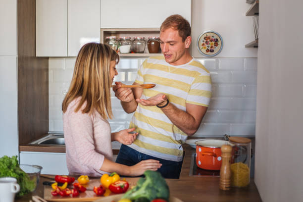 istock Man giving his wife a taste test during breakfast preparation 1215214510