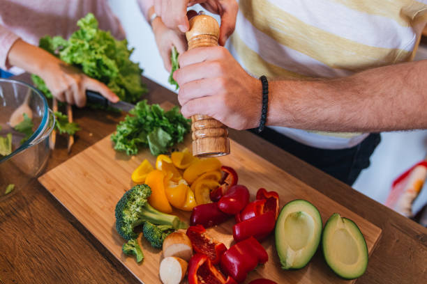istock Man seasoning vegetables during breakfast preparation 1215214512