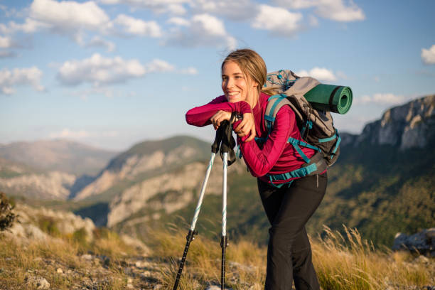 istock Tired woman resting after climbing a mountain 1215215438
