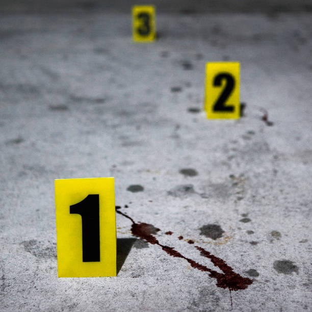 Close up of an evidence marker and blood splatter at a crime scene.