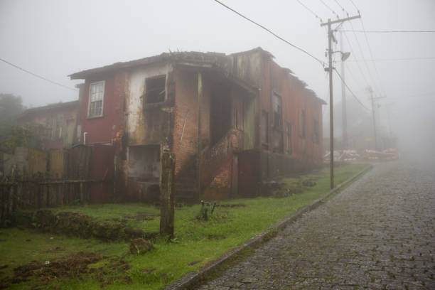 Paranapiacaba Village, Santo André, SP, Brazil - March 01, 2020: Ruined house in the city, on a cobbled stone street, under the strong fog characteristic of the region.