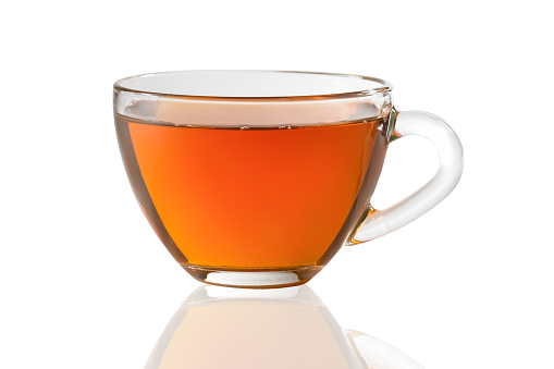 Glass cup of black tea isolated on a white background.