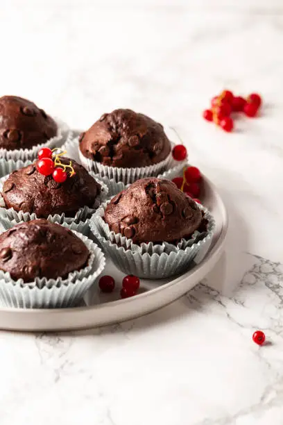 Chocolate muffins with zucchini. Muffins served with redcurrant.