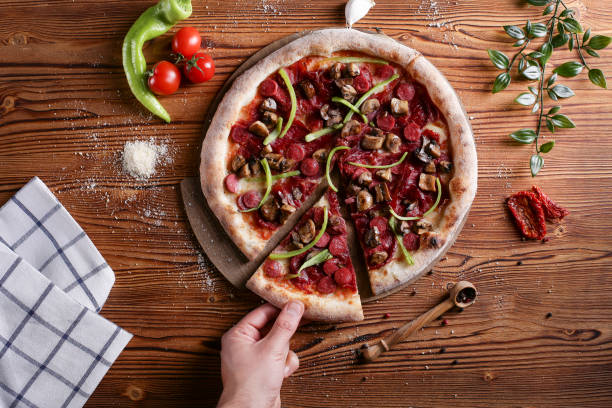 istock men taking slice of pepperoni pizza on black table 1215224593