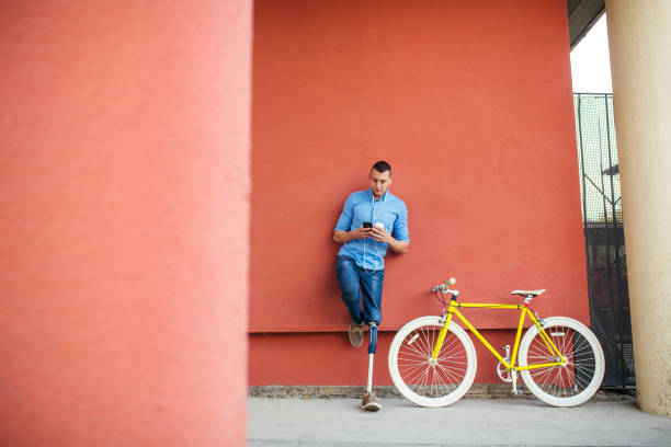 istock Young male with prosthetic leg standing next to bicycle 1215227962