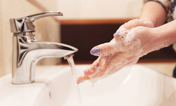 istock Coronavirus prevention, washing hands with soap 1215229078
