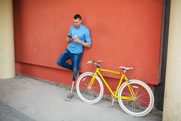 istock Young male with prosthetic leg standing next to bicycle 1215230195