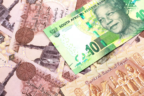 a ten south african rand bank note on a bed of egyptian pound notes - ten rand note imagens e fotografias de stock